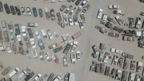Drone looking down at a large salvage yard Stock Footage 192567284