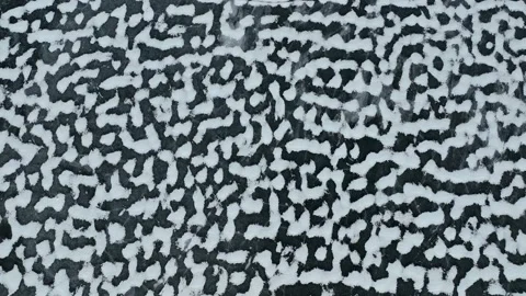 Drone looking down on Snow scattered across a frozen lake Stock Footage 168583810