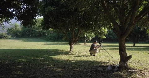 The drone looking for a man take video in park at Chiang Mai Thailand Stock Footage 100745406