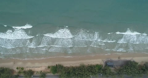 Drone looking over the sea watching the waves roll in at Mae Pim beach Stock Footage 108414631