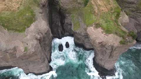 Drone Looks Down Into Cliffs on Ocean Stock Footage 303499733