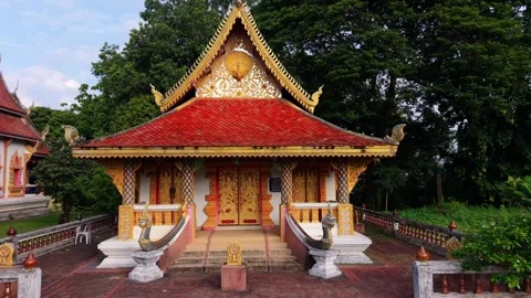 Drone low-altitude tracking shot approaching Buddhist temple pavilion Stock Footage 336297536