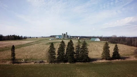 Drone low and long approach to quebec dairy farm spring Stock Footage 93363044