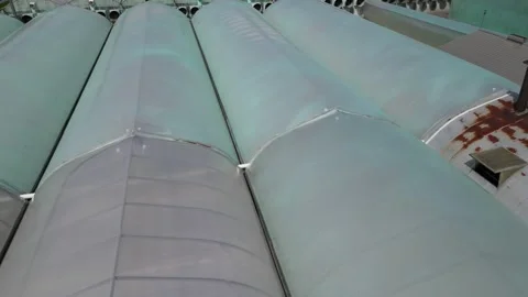 Drone - Low Cruise Down to Up Over Greenhouses Stock Footage 314228208