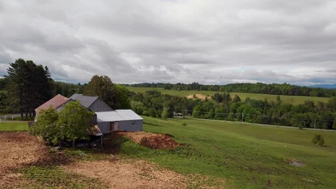 Drone low lateral moving away from quebec farmhouse in spring, 4k Stock Footage 91153718