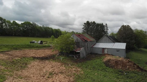 Drone low orbit old quebec farmhouse, vehicles in spring, 4k Stock Footage 91153792