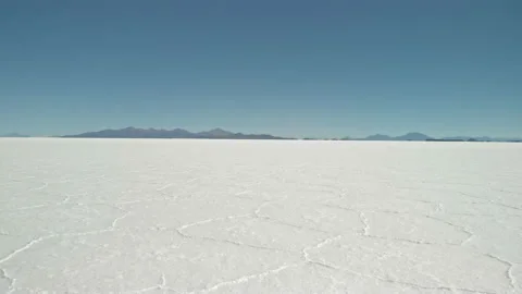 Drone low over salt flat ground with hexagon shape pattern in Salar de Uyuni Stock Footage 176022621