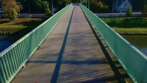 Drone Low reverse over footbridge reveals parallel linear perspective Stock Footage 319998682