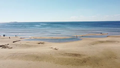 Drone low Tide on the Beach Han Purple sea Light Cornflower Blue sky Stock Footage 134284990