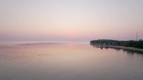 Drone at low tide at sunset. Everything is pink, purple sky people on beach Stock Footage 278310170