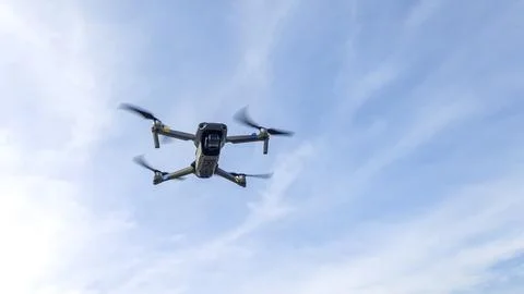 Drone machine with blue sky background for commercial marketing. Drone servic Stock Photos
