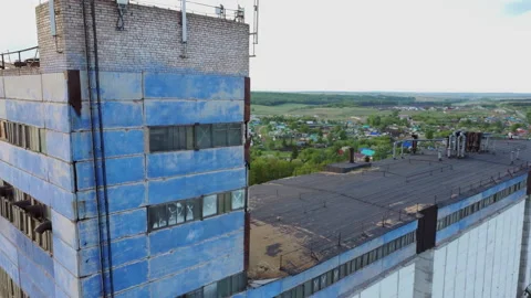 Drone makes an evening flight over abandoned factory granary on cloudy day in Stock Footage 137698861