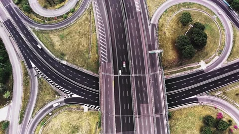 Drone making circular motion over traffic intersection where cars are moving and Stock Footage 227024002