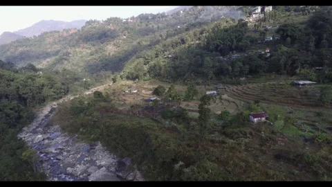 Drone malfunctioning while flying over a river valley surrounded by mountain Stock Footage 274253870