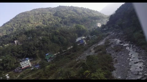 Drone malfunctioning while flying over a river valley surrounded by mountain Stock Footage 274253996