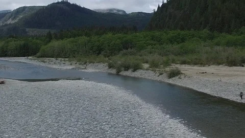  Drone Man Walking Along River Pan Right Video stock 92170284