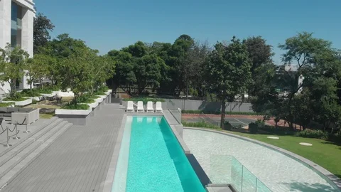 Drone of man walking to pool Stock Footage 120334536