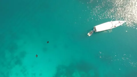 Drone, manta rays and boat in clear blue ocean Stock Footage 131436676