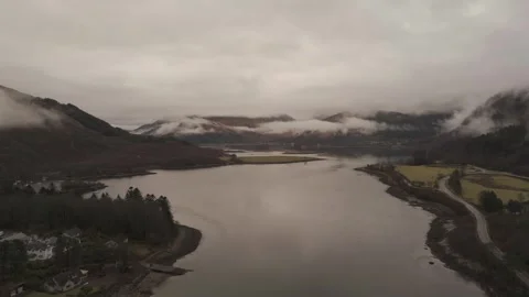 Drone Mists clinging to mountains surrounding Highland Loch 4K Stock Footage 299318817