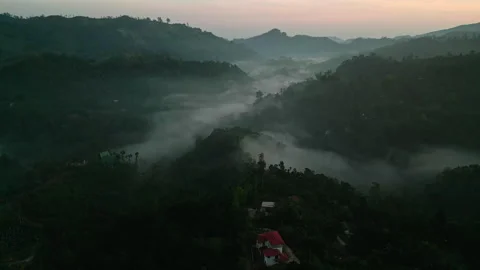 Drone misty dawn breaking over Ella mountains, Sri Lanka. Glimpses of green Stock Footage 275104969