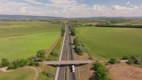 Drone motion over Austrian autobahn amid fields Stock Footage 264002500