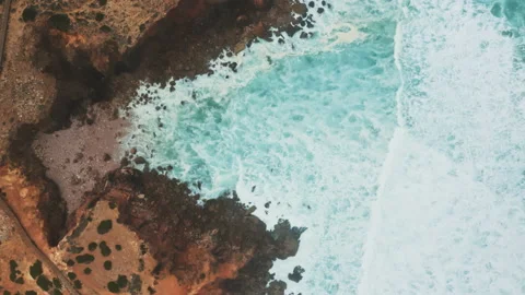 Drone in movement above wild ocean coast showing waves Stock Footage 203597908