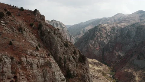 Drone movement over Armenian brick red cliffs and rocks near Noravank monastery Stock Footage 171180239