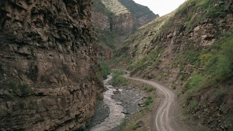 Drone moves along the mountain river in canyon Stock Footage 165512631