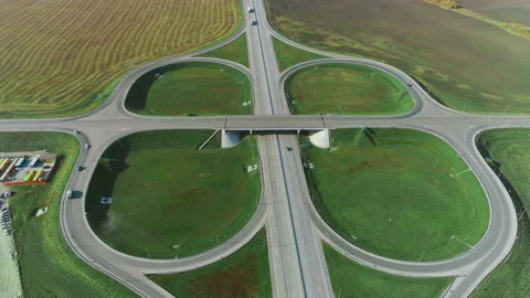 The drone moves around a traffic intersection. Trucks and cars drive along the Stock Footage 133803675