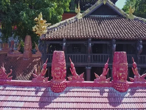 Drone Moves from Carved Holy Pink Figures to Golden Dragon Stock Footage
