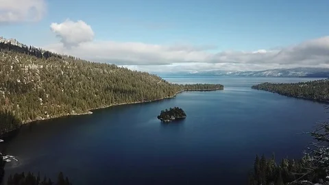 Drone moves to the left from behind a tree revealing Emerald Bay Stock Footage 83229103