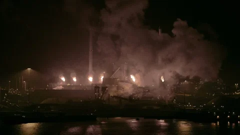 A drone moves from left to right and reveals an industrial old factory at night. Stock Footage 100759603
