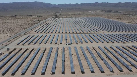 Drone moves left to right over large solar farm in desert - Shot 4K Stock Footage 150649488