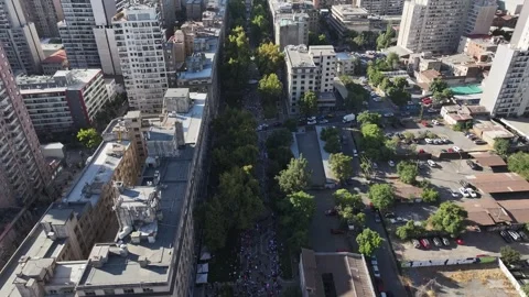 Drone moves from overhead crowd to Chilean flag at La Moneda Santiago Chile Stock Footage 332532759