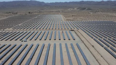 Drone moves right to left over solar farm in desert - Shot 4K Stock Footage 150649474