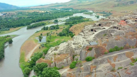 Drone moves sideways across Uplistsikhe in Georgia, presenting carved caves Stock Footage 340764434
