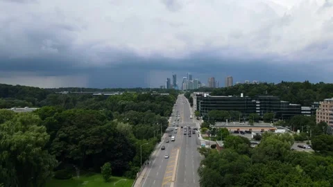 Drone Moves Toward Thunderstorm, Capturing Skyscrapers and Greenery Stock Footage 291371300