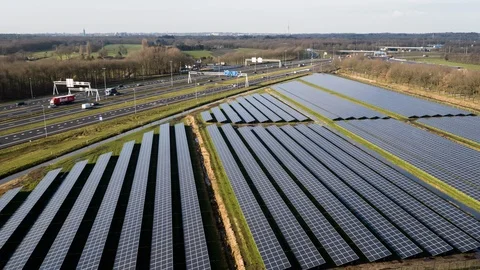 Drone moves towards the highway and shows a large solar panels farm. Stock Footage