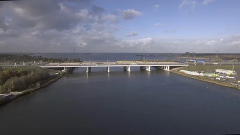 A drone moves towards a highway bridge while a lot of cars passes by Stock Footage 100758461