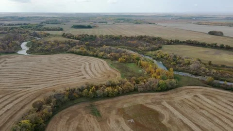 Drone moving ahead high above harvested farmland  Stock Footage 252835124