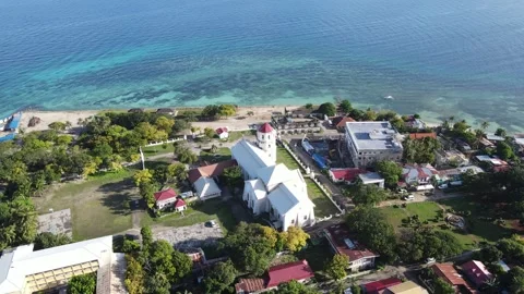 Drone is moving around the chuch at the beach - Philippines Stock Footage 301615136