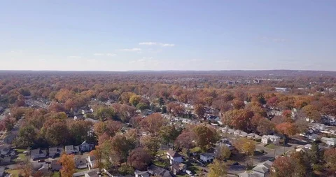 Drone moving backward over fall town 動画素材 98436568