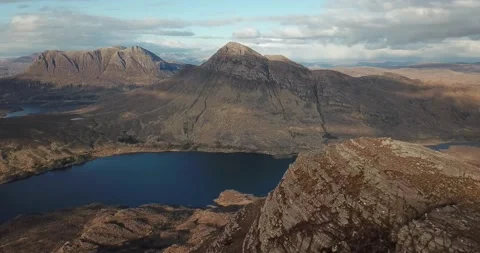 Drone moving backwards Assynt mountains from summit Stock Footage 169497685