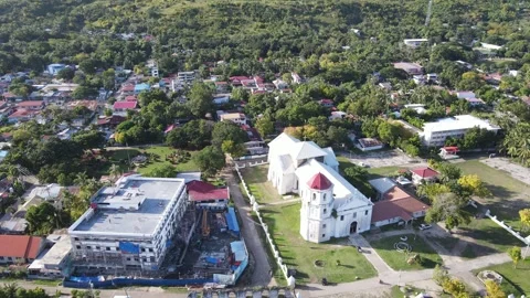 Drone moving backwards from a chruch to the sea - Philippines Stock Footage 301614460