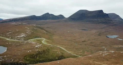 Drone moving backwards NC500 and Assynt mountains Stock Footage 169393429