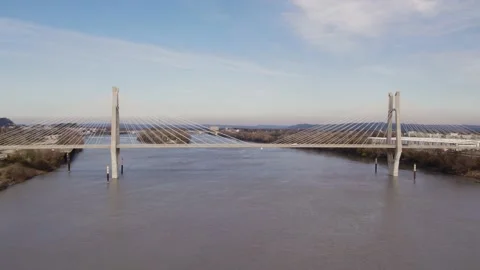 Drone Moving Backwards over the river showing a cable-stayed bridge Video stock 227374771