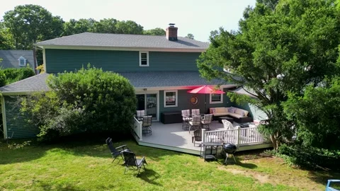 Drone moving closer to a backyard deck set up for a party Vidéo 283300963