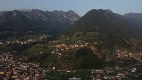 Drone moving closer to the mountains and villages Video stock 157726428