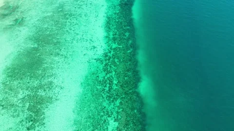 Drone moving forward along turquoise and deep blue waters, Koh Ngai – 4K Stock Footage 325022366