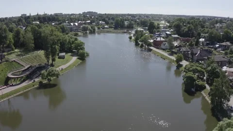 Drone moving forward and down over urban pond Video stock 331740954